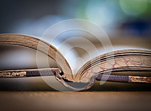 Opened old book on a wooden table