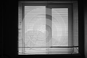 Opened old horizontal metal jalousie. Background blinds. Black and white photo