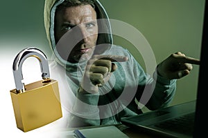 Opened padlock composite with young dangerous and skilled hacker manprogramming on laptop computer system cracking password in