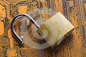 Opened padlock on computer motherboard. Internet data privacy information security concept.