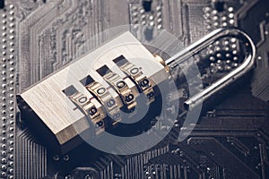 Opened padlock on computer motherboard. Internet data privacy information security concept. Toned image