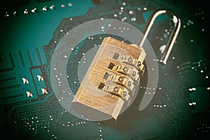 Opened padlock on computer motherboard. Internet data privacy information security concept. Toned image