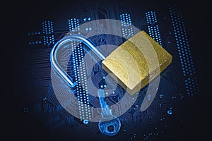 Opened padlock with a key on computer motherboard. Internet data privacy information security concept. Blue toned image