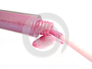 Opened pink gloss for lips on white background