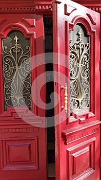Entrance through ornate red door of historic building in European city Odessa of Ukraine