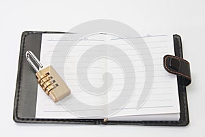 Opened retro paper notebook with padlock combination security