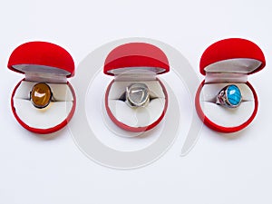 Opened round red jewelry boxes on white background