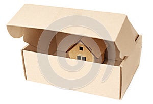 Opened shipping box with a small house inside