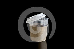 Opened take-out coffee with cup holder. Isolated on black background with Reflections