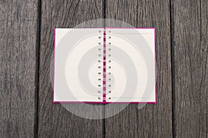 Opened white page of blank realistic spiral notepad notebook on wood texture background. Vintage style