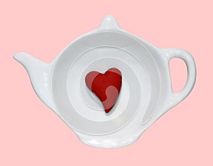 Opened white saucer cup of tea, red heart inside, isolated background, flat lay, top view. Copy space. Love coffee or tea concept