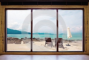 Opened window seeing tropical beach view in summer holiday at weekend house and resort photo