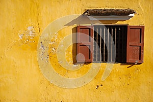 Opened-window on yellow wall