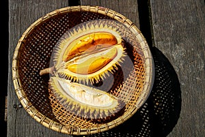 Opened Yellow Durian Fruit in a Rattan Basket on an Old Wooden Table in Sarawak Borneo