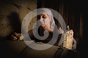 Opening barrel in medieval wine cellar