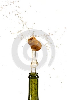 Opening a bottle of champagne, cork flyes out of the bottle with splashes