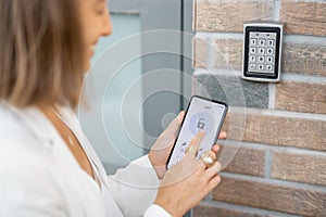 Opening door with a smart phone and keyboard on the wall