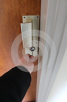 Opening a front door to house with key concept of security or new home