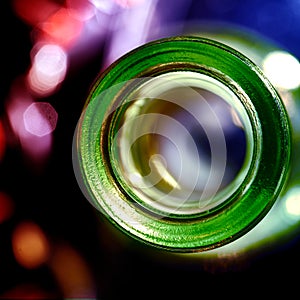 Opening of glass bottle from above with bokeh background, empty bottle concept, drinking, alcohol