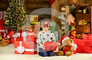 Opening his Christmas present. merry christmas. happy child party glasses. son ready to celebrate winter holidays. small