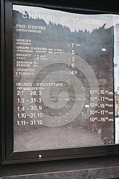 Opening hours and admission fees board outside Vianden Castle, Luxembourg