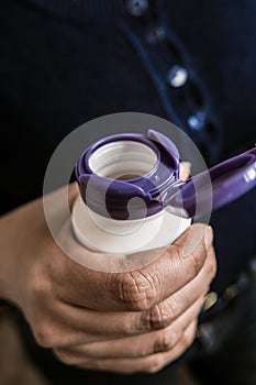 Opening a medicine bottle. Pill box open lid in womens hand