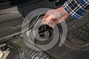 Opening the oil cap from a car engine