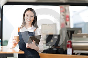 Opening a small business, AHappy Asian woman in an apron standing near a bar counter coffee shop, Small business owner