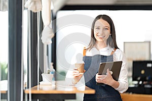Opening a small business, AHappy Asian woman in an apron standing near a bar counter coffee shop, Small business owner