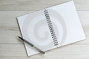 Opening white blank note paper and pen on the left with on light