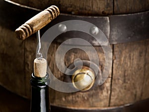 Opening of a wine bottle with corkscrew.