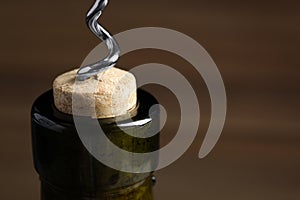 Opening wine bottle with corkscrew, closeup. Space for text