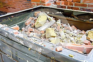 opentop steel dumpster filled with demolition debris
