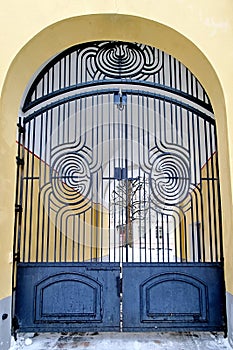 Openwork iron gate leading to the courtyard of a house