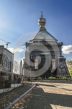 Openwork wrought iron gate to the Park `Hill of Honor` with a view of the 19th-century Russian Orthodox Church of St. Michael the