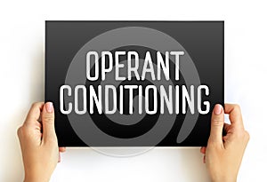 Operant Conditioning is a method of learning that uses rewards and punishment to modify behavior, text concept on card