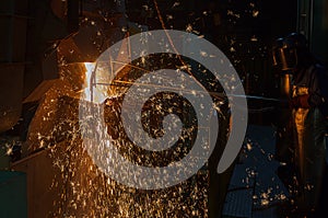 Operater tapping molten metal