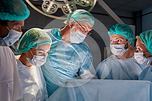 Operating room caucasian team of professional surgeons and nurses working together