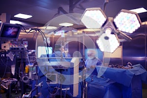 Operating room with working doctor`s team during surgical proced