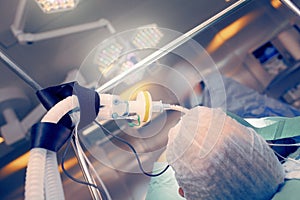 Operating room with working staff next to the patient photo