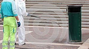 operating staff during the disinfestation of city waste baskets