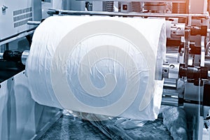 The operation of automatic plastic bag production machine. Close-up of the roller of the polyethylene bag production machine.  mac
