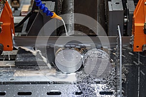 The operation of band saw cutting machine cutting the metal shaft parts with coolant method