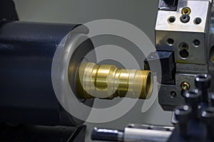 The operation of CNC lathe machine cutting the pipeline connector parts with lighting effect.