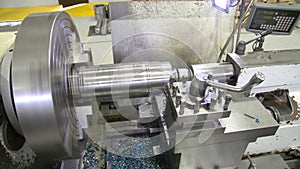 The operation of lathe machine cutting the metal shaft parts. The metalworking process by turning machine.