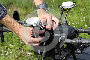 Operator adjusting quadcopter before launching it