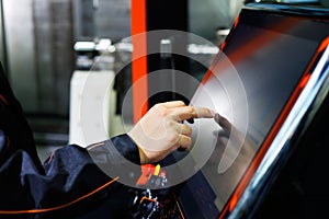 Operator adjusts CNC machine using touch screen