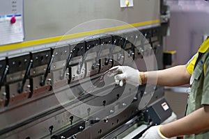 Operator bending metal sheet by sheet bending machine