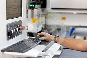 Operator controls a modern woodworking CNC machine