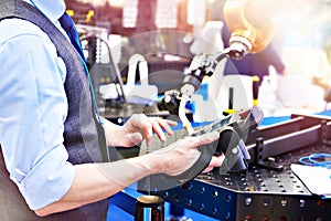 Operator controls a robotic welding machine